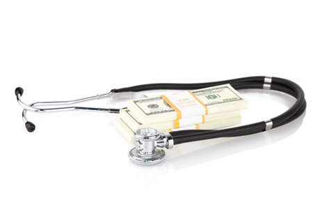 stethoscope placing on US dollar banknotes on white backgroundの写真素材