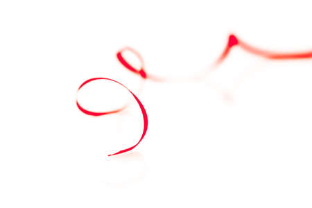 Red ribbon bow isolated on white backgroundの写真素材
