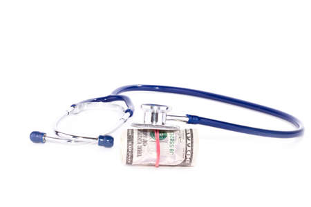 Doctor stethoscope with cash in dollars over whiteの写真素材