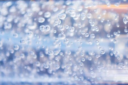 Transparent bubbles in the gel liquid. Light blue backgroundの写真素材
