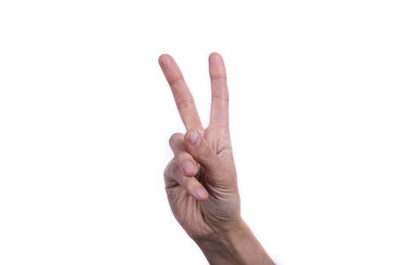 Female hand close-up on a white background. Symbol of peaceの写真素材