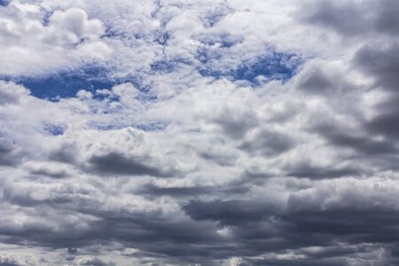 Grey rain clouds in the daytime. Bad weather. Grey clouds before a thunderstormの写真素材