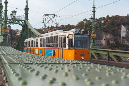 Budapest, Hungary-October 8, 2019: Tram numbre 49 circulating on the Liberty Bridge, in Budapest, Hungary.のeditorial素材