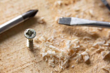 Close up wood threaded lag screw and two hand screwdriversの写真素材