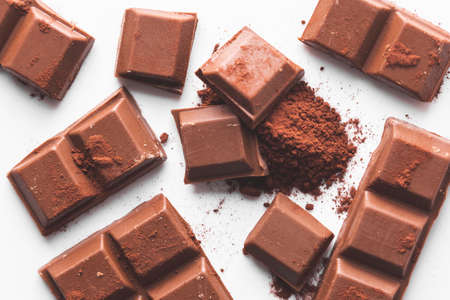 close-up shot of a few ounces of chocolate on cocoa powder. Dark background.の写真素材