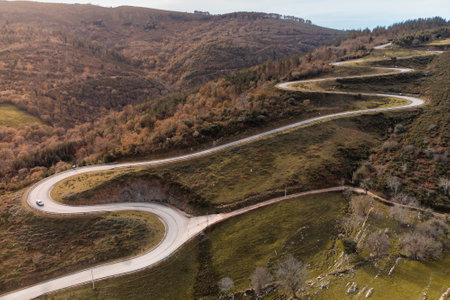 Aerial view of the road to the El Soplao cave, in Cantabria, Spain.Drone view.Aerial view mountain road with many sharp curves.dngの写真素材