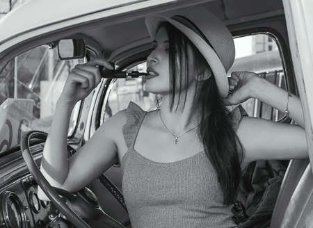 two beautiful girls and retro cars at natureの写真素材