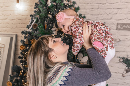 Happy young mother with her sweet baby at christmas