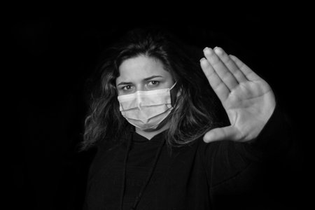 black and white stop the virus and epidemic diseases. Healthy woman in blue medical protective mask...