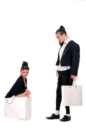 A man looks at a woman, sitting in a bag on a white backgroundの写真素材