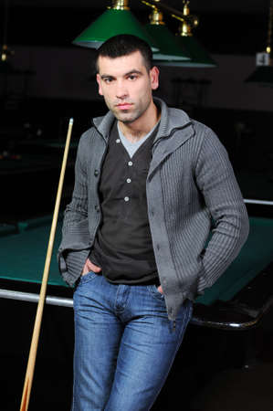 Portrait of a young man playing snookerの写真素材