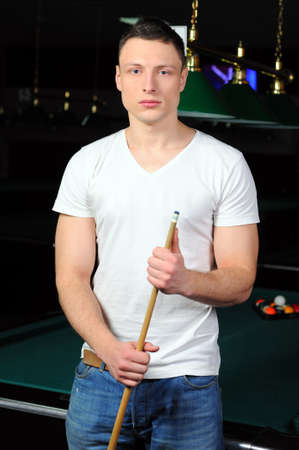 Portrait of a young man playing snookerの写真素材