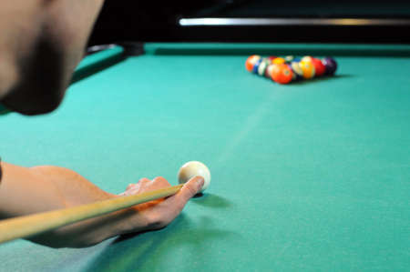 Man playing snooker in the dark club の写真素材