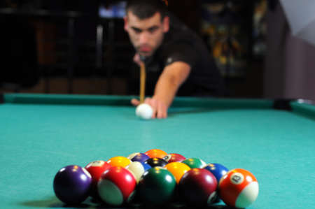 Man playing snooker in the dark club の写真素材