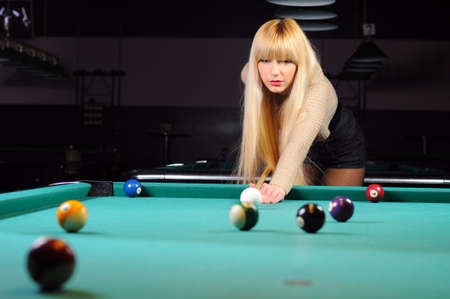 Young girl playing snookerの写真素材