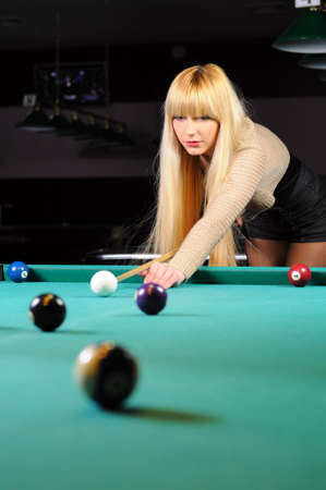Young girl playing snookerの写真素材