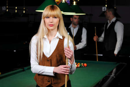 Portrait of a young girl playing snookerの写真素材