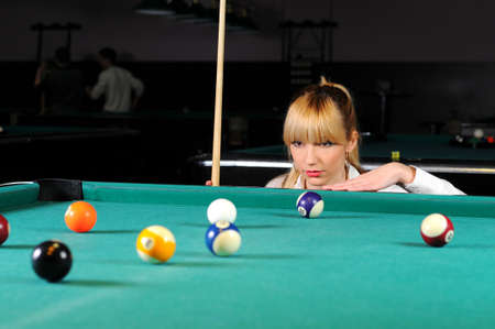 Young girl playing snookerの写真素材