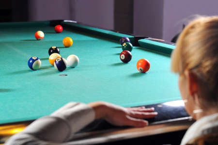 Young girl playing snookerの写真素材