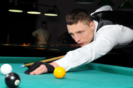 Young person playing snooker in a clubの写真素材
