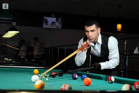 Young person playing snooker in a clubの写真素材