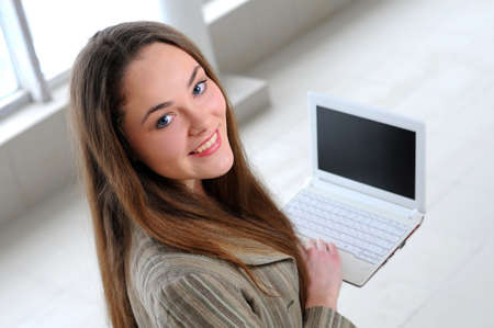 young girl with laptop in officeの写真素材