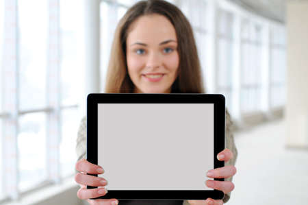 young girl with a tablet in office  focus tabletの写真素材