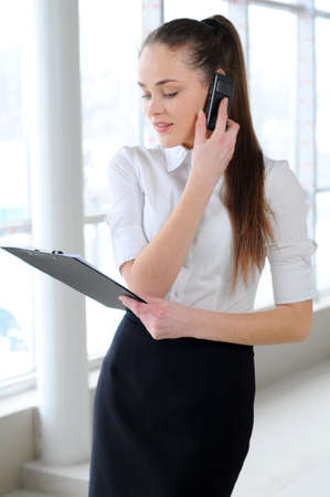 young business girl talking on the phone in the officeの写真素材