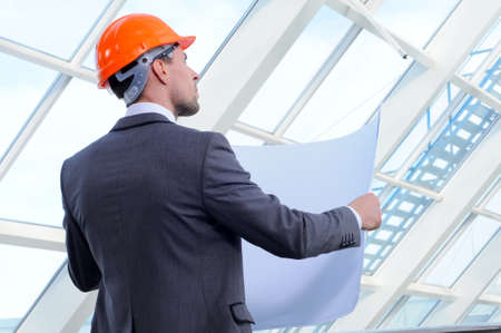 architect looking comparing housing project with buildingの写真素材
