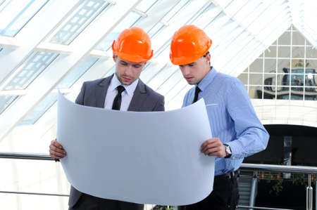 Two men in hard hats at construction siteの写真素材