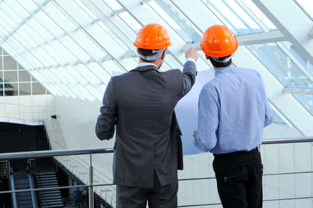 Two men in hard hats at construction siteの写真素材
