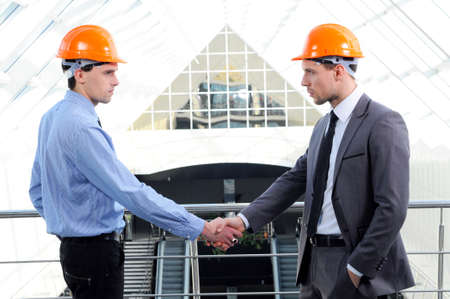 Two men in hard hats at construction siteの写真素材