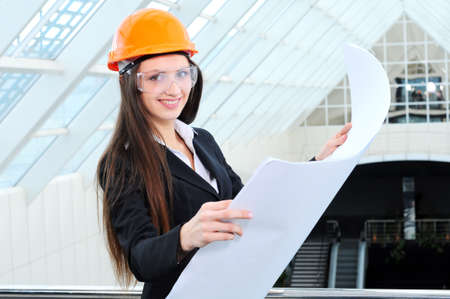 Portrait of a beautiful business woman on background of modern buildingの写真素材