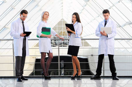 doctors do their job against modern hospital buildingの写真素材
