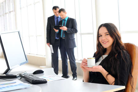 business woman drinking coffee at officeの写真素材