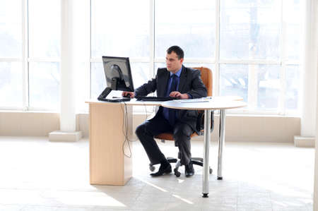 businessman working with a computer in a large officeの写真素材