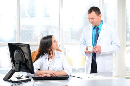 Male   female medical doctors using computer in a hospital officeの写真素材