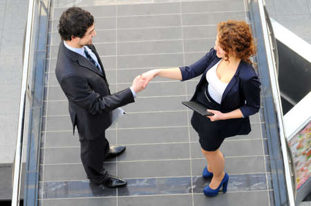 Confident business partners in office building  view from aboveの写真素材