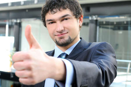 Portrait of a smiling businessman giving thumbs upの写真素材