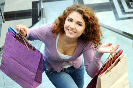 Beautiful shopping woman at a drawn mallの写真素材