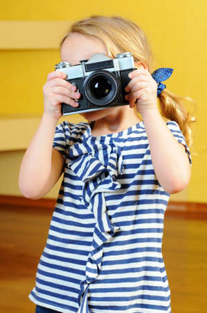 Young photographer, holding a retro rangefinder cameraの写真素材