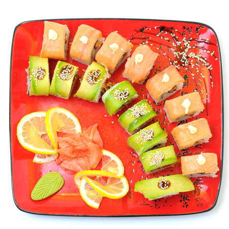 Japanese traditional Cuisine - Rolls with Cucumber , Cream Cheese with raw Tuna and Salmon inside  on red dish with sticks isolated over white backgroundの写真素材