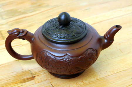 stylish tea pot on wooden tableの写真素材