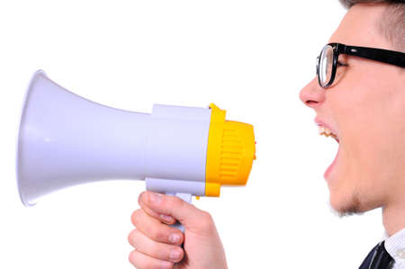 Young business man shouting into a megaphone isolated over a white backgroundの写真素材
