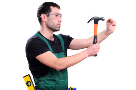 Young builder man holding hammer isolated on white backgroundの写真素材