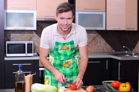 Man in kitchen preparing dinnerの写真素材
