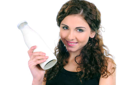 portrait of a lovely young lady having a glass of milk against white backgroundの写真素材