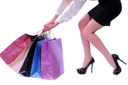 Beautiful stylish woman pulling shopping bagsの写真素材