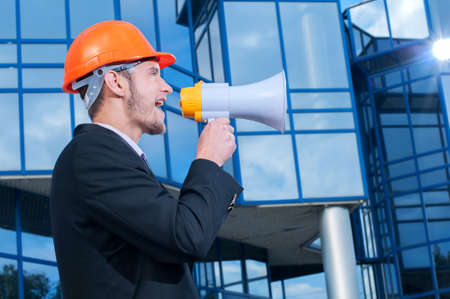 Man wearing helmet speaks with megaphoneの写真素材