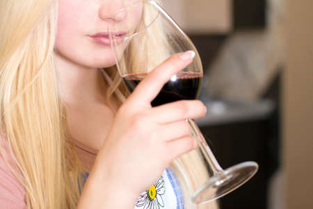 Kitchen Woman. Pretty woman drinking some wine at homeの写真素材